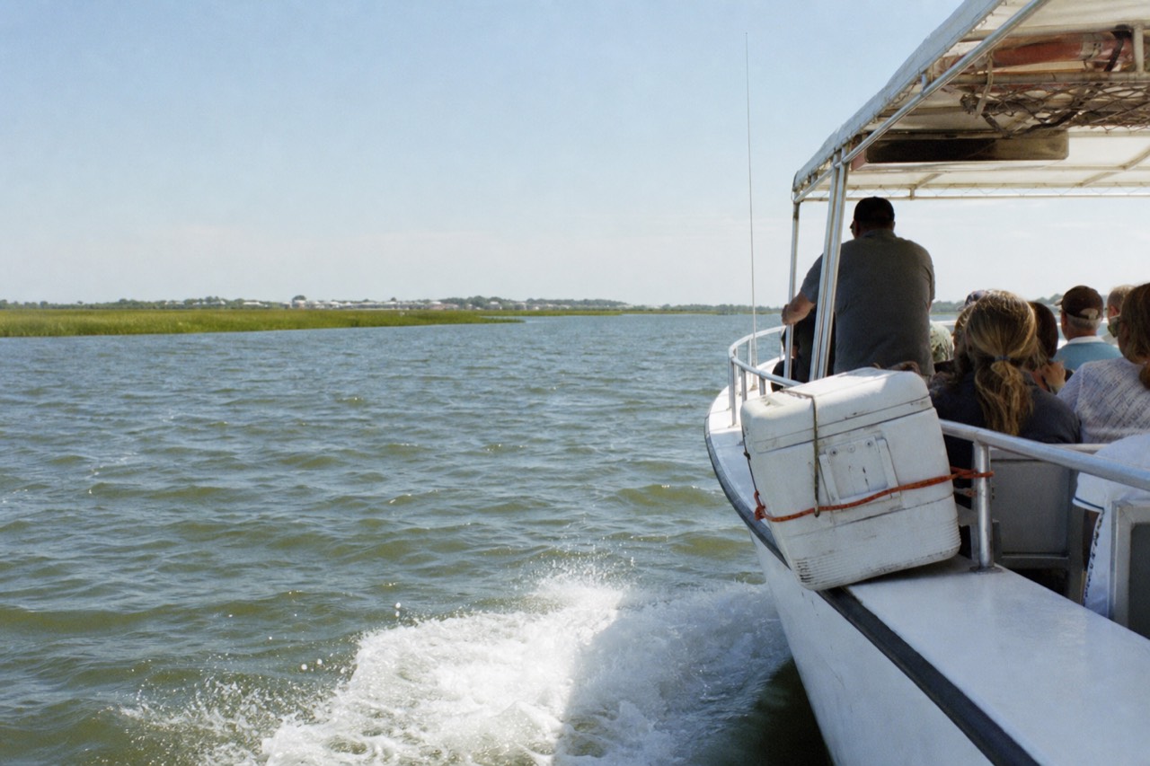 A small passenger boat cruising coastal Georgia waters near Tybee Island, no text, no logos, no people