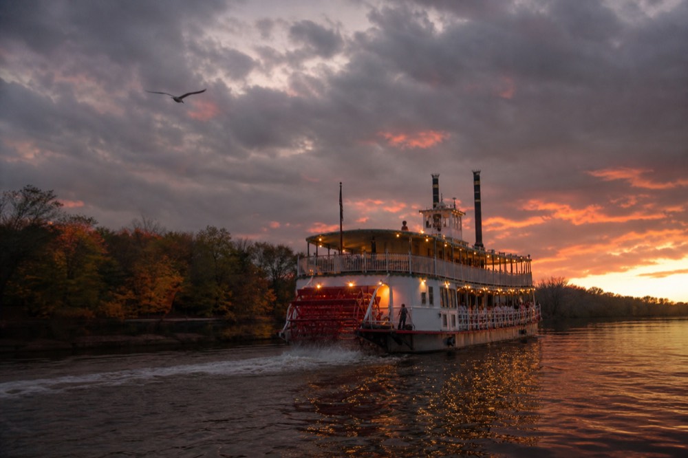 Paddlewheel riverboat cruising the Savannah River at sunset, no text, no logos, no people