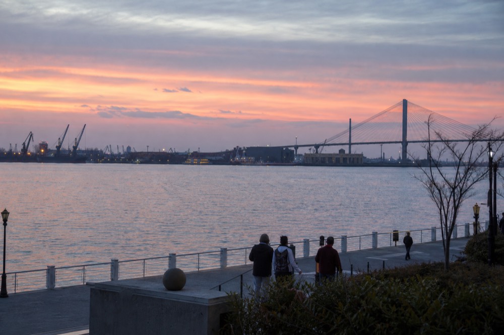 Wide view of the Savannah riverfront and bridge at dusk, no text, no logos, no people