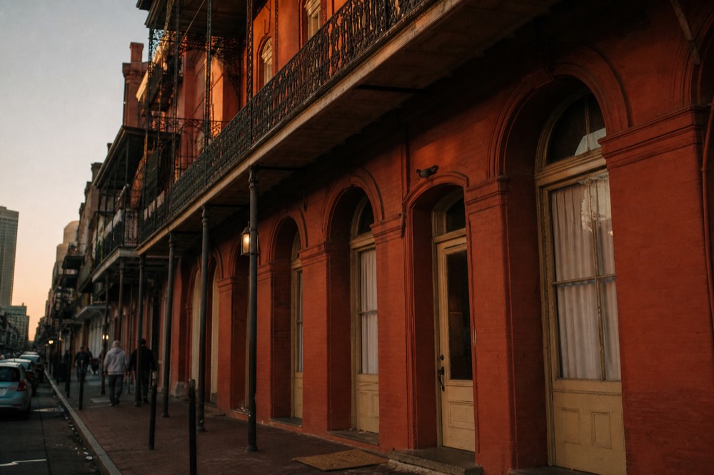 The facade of a historic 19th-century Savannah hotel at twilight, no text, no logos, no people