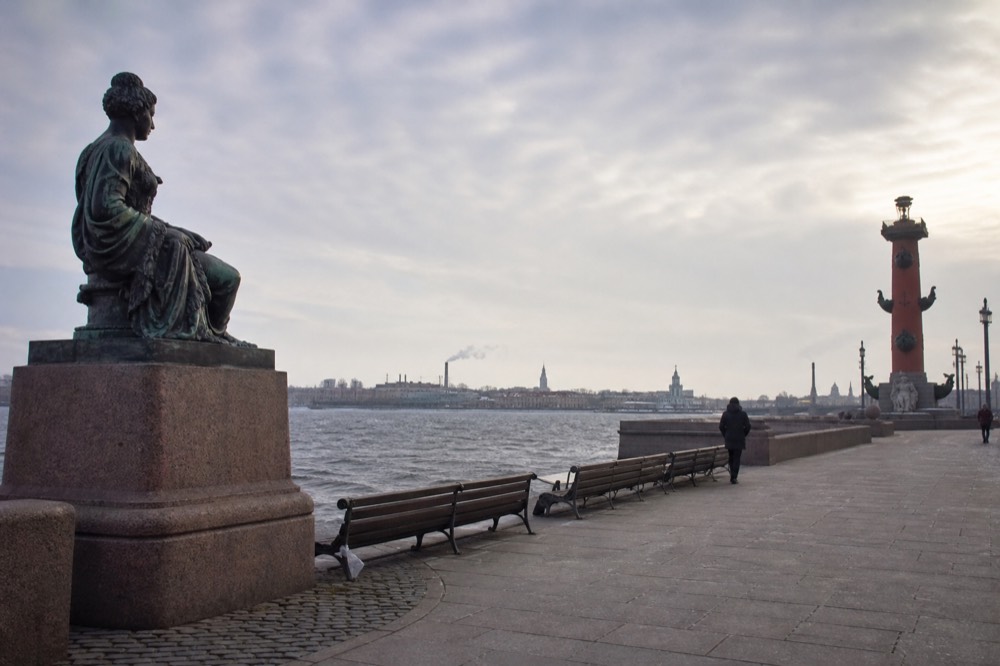 Riverside monuments and promenade benches on Rousakis Plaza, no text, no logos, no people