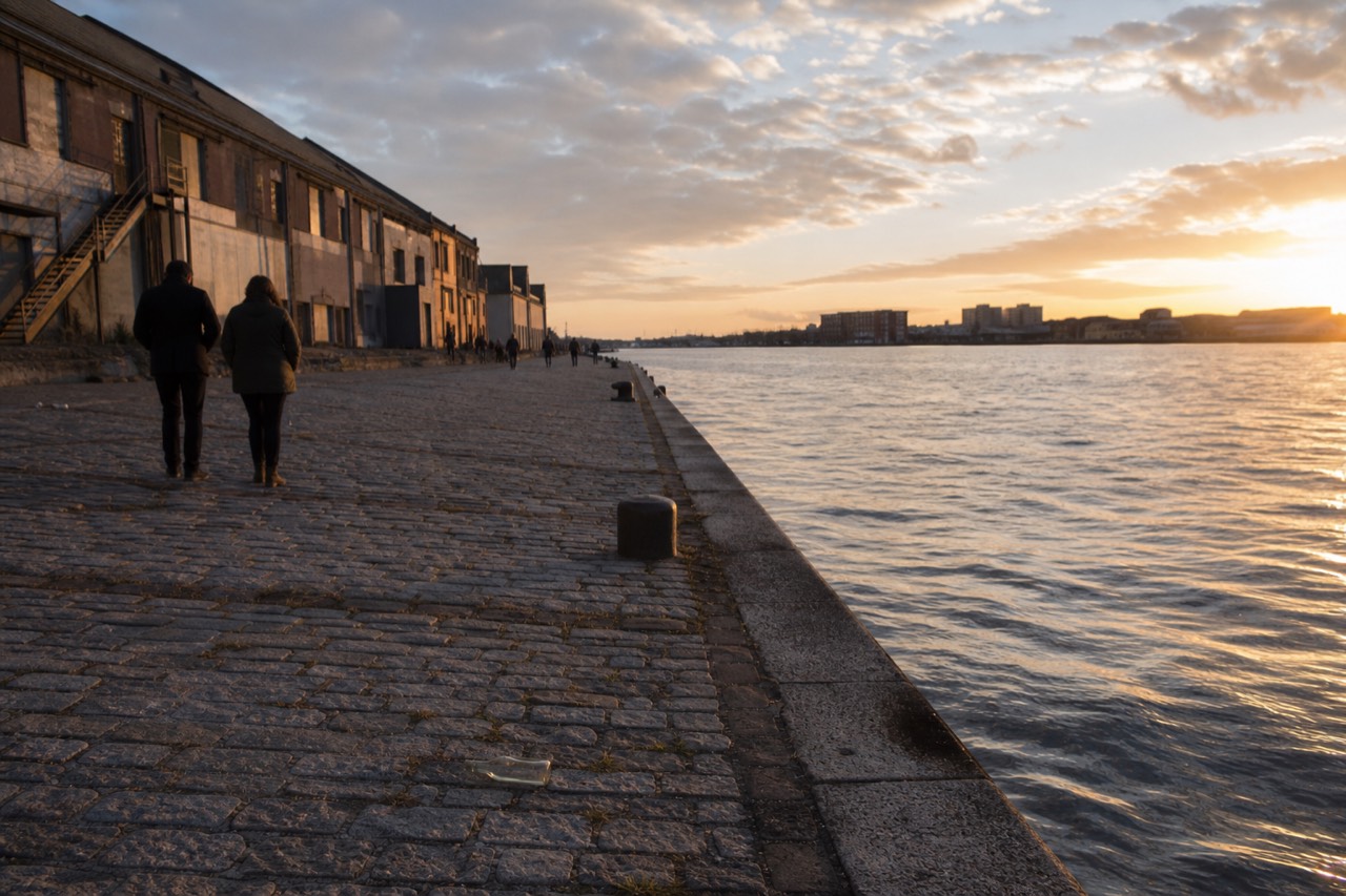 Cobblestone River Street along the Savannah River at golden hour, no text, no logos, no people.