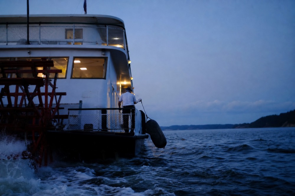 Paddlewheel riverboat underway on the Savannah River at twilight, no text, no logos, no people