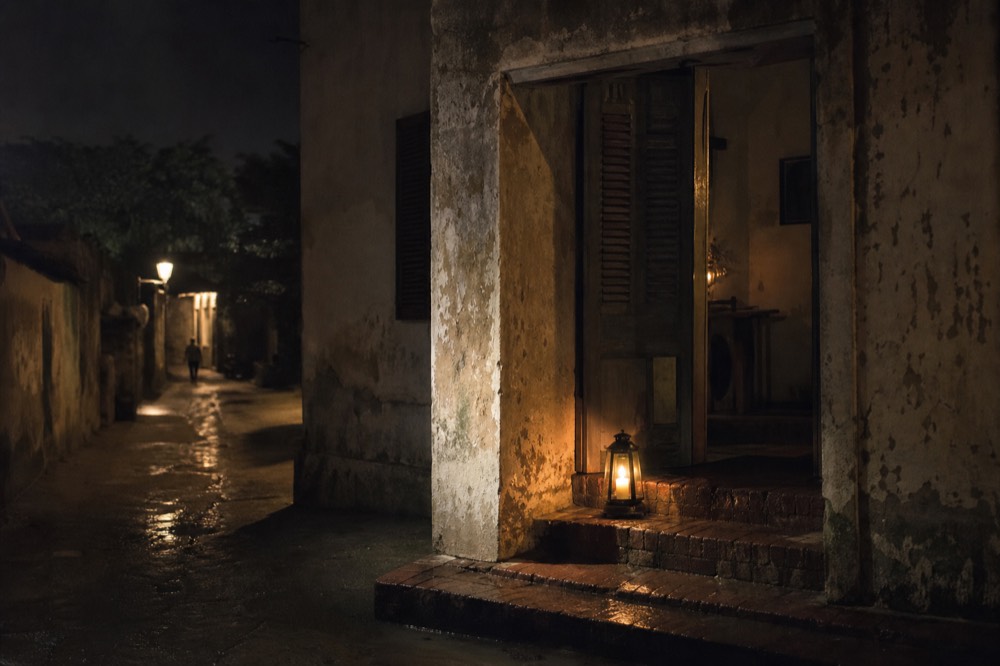 Candlelit doorway of a historic Savannah building at night, no text, no logos, no people