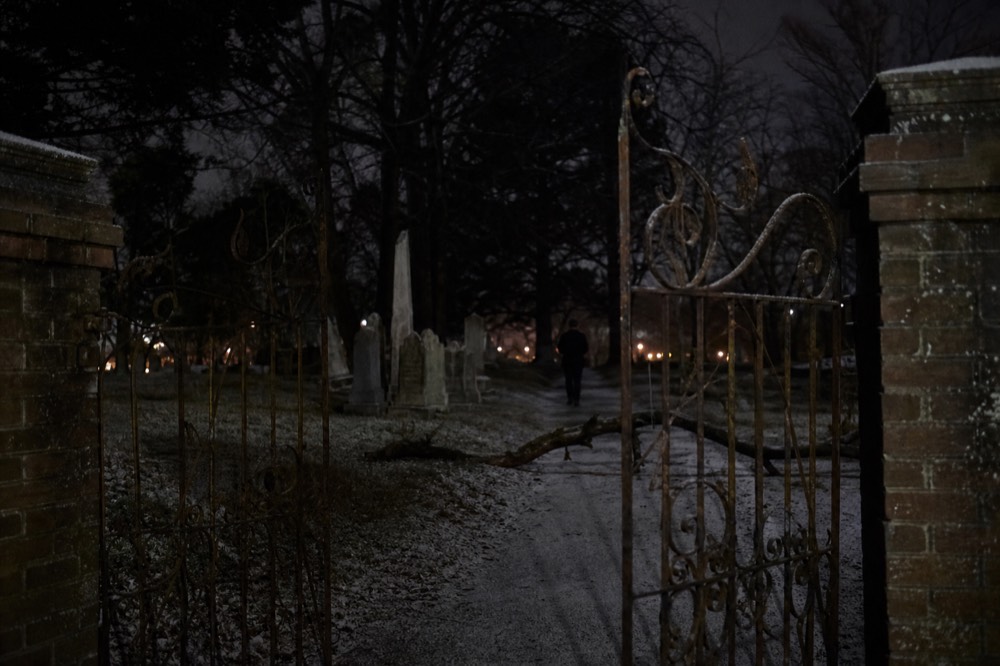 Old Savannah cemetery gate at night with ironwork, no text, no logos, no people