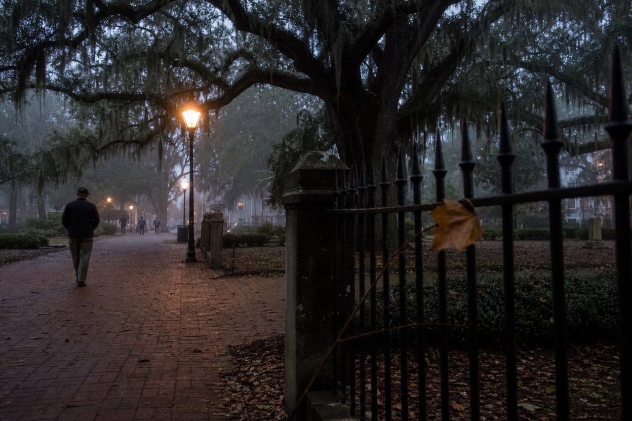 Lantern-lit Savannah square at dusk with live oaks and mist, no text, no logos, no people