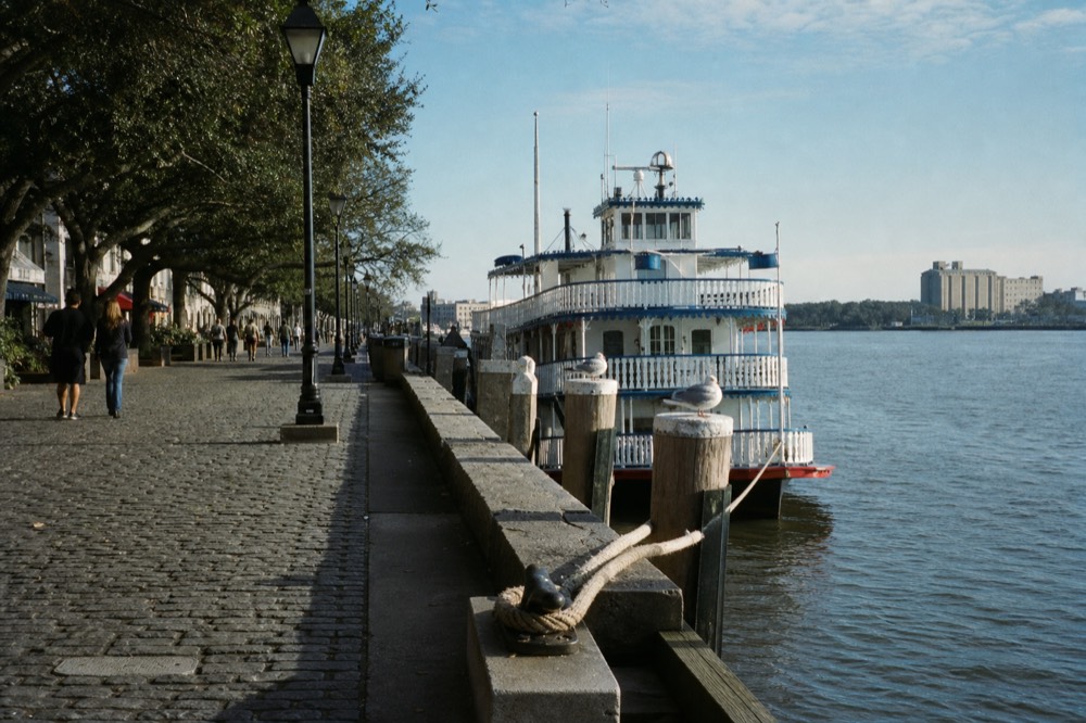 Paddlewheel riverboat docked on the Savannah River beside River Street, no text, no logos, no people