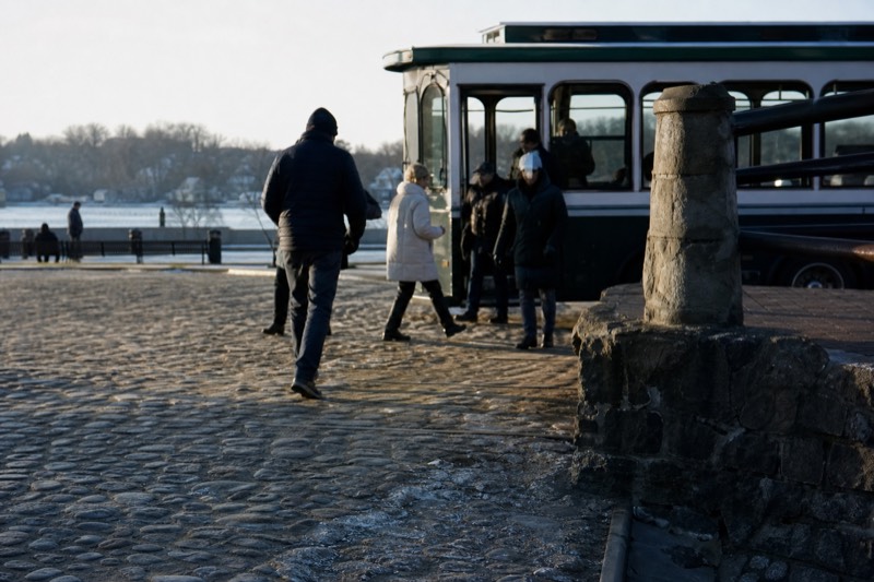 A riverboat docked on River Street beside a historic trolley on the cobblestone waterfront in Savannah, near West Boundary Street in downtown Savannah
